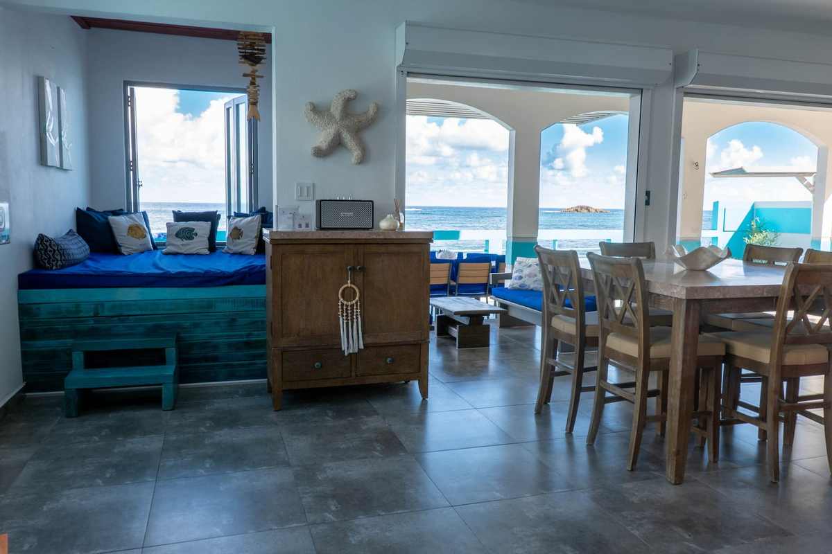 Open living and dining room with ocean views and coastal decor