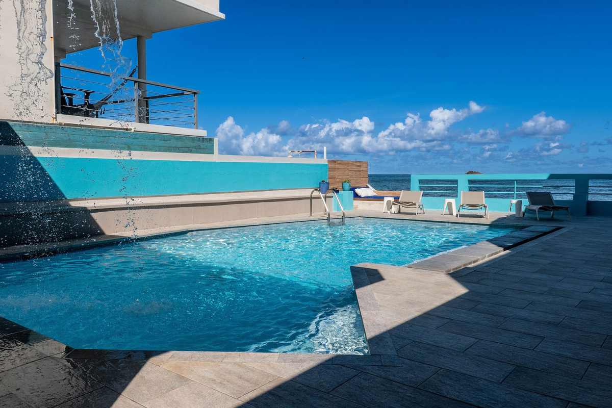 Turquoise private pool with the Atlantic ocean just beyond the terrace wall
