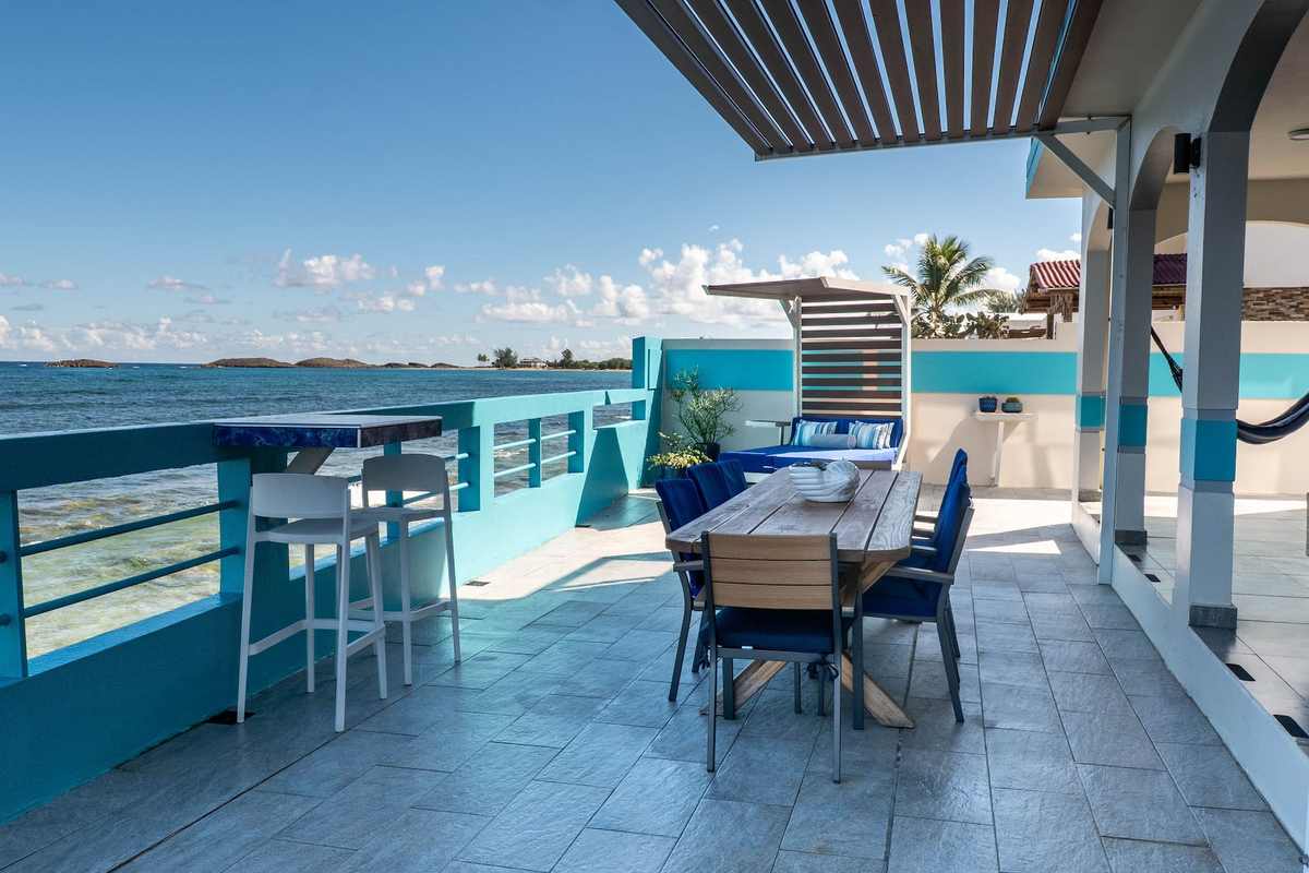 Rooftop deck with outdoor dining table overlooking the coastline