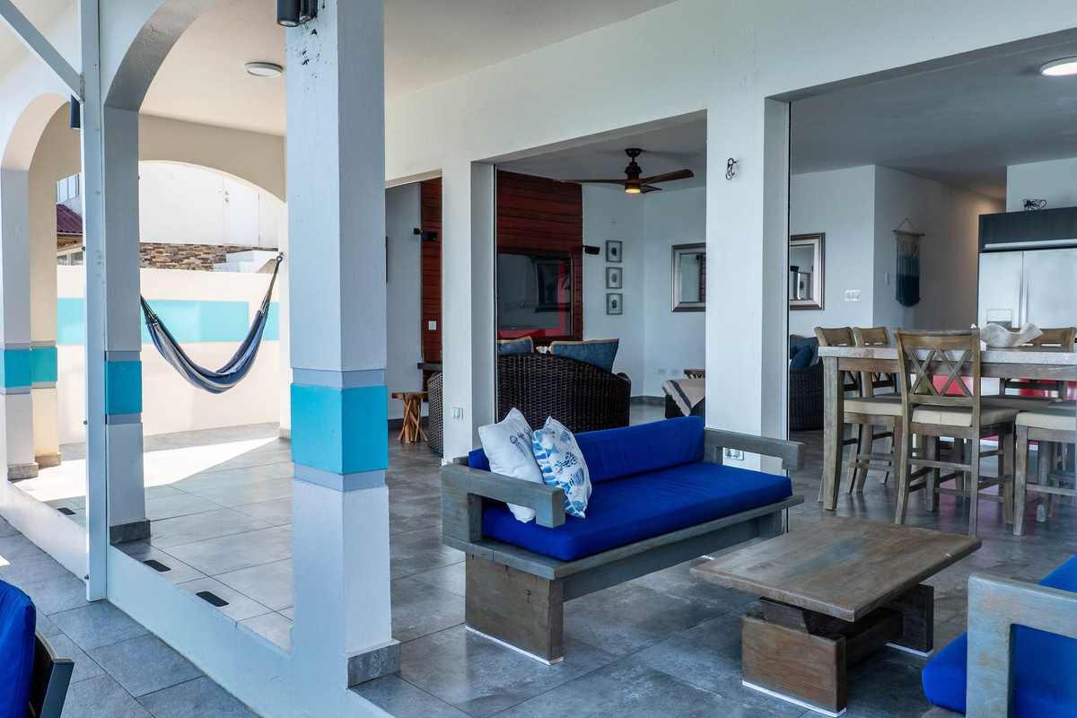 Covered terrace with hammock, sofas and dining table
